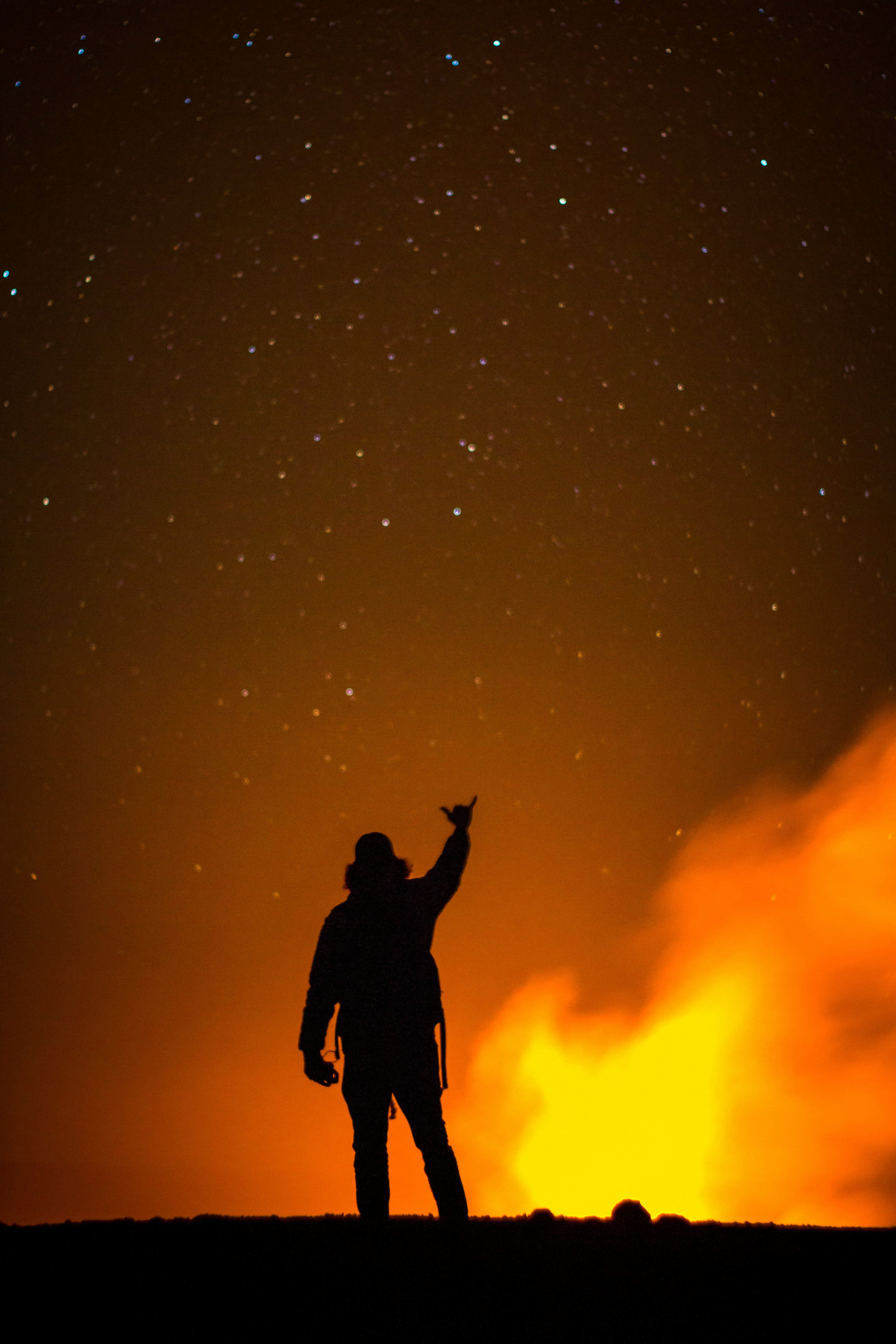 silhouette of man raising right hand